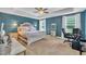 Spacious primary bedroom showcasing a tray ceiling, neutral carpeting and ensuite bathroom at 1109 Agio Ct, Zebulon, NC 27597