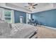 Bright primary bedroom showcasing a tray ceiling, neutral carpeting, and natural light at 1109 Agio Ct, Zebulon, NC 27597
