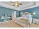 Bright primary bedroom featuring a tray ceiling, neutral carpet, and ensuite bathroom access at 1109 Agio Ct, Zebulon, NC 27597