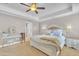 Bright main bedroom with tray ceilings, neutral decor, and an ensuite bathroom at 1109 Agio Ct, Zebulon, NC 27597