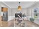 Open-concept space with a modern office setup, decorative wall hangings, and wainscoting at 1109 Agio Ct, Zebulon, NC 27597