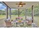 Inviting screened patio with comfortable seating, ceiling fan, and serene backyard views at 1109 Agio Ct, Zebulon, NC 27597