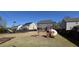 Large backyard with playground equipment, perfect for outdoor fun and Gathering activities at 1116 Trotter Bluffs Dr, Holly Springs, NC 27540
