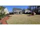 Expansive backyard with a playset and mature trees, providing ample space for outdoor activities at 1116 Trotter Bluffs Dr, Holly Springs, NC 27540