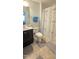 Bright bathroom featuring a shower with white shower curtain, toilet, and dark vanity at 1116 Trotter Bluffs Dr, Holly Springs, NC 27540