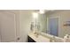 Bathroom with a large mirror, vanity with a sink and modern light fixtures at 1116 Trotter Bluffs Dr, Holly Springs, NC 27540