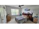 Bright bedroom features natural light, carpeted floors, and a ceiling fan for added comfort at 1116 Trotter Bluffs Dr, Holly Springs, NC 27540