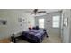 Bright bedroom featuring a ceiling fan, window, and unique decor on white walls at 1116 Trotter Bluffs Dr, Holly Springs, NC 27540