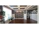 Dining room featuring coffered ceilings, modern lighting, and dark wood floors at 1116 Trotter Bluffs Dr, Holly Springs, NC 27540