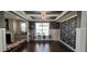 Bright dining room with coffered ceiling, large window, and dark wood floors at 1116 Trotter Bluffs Dr, Holly Springs, NC 27540