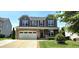 Charming two-story home with stone accents, attached two car garage, manicured lawn and complementary landscaping at 1116 Trotter Bluffs Dr, Holly Springs, NC 27540