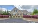 Charming exterior of a home with stone accents, a covered porch, and well-manicured landscaping at 1116 Trotter Bluffs Dr, Holly Springs, NC 27540