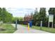 Inviting greenway entrance features a paved path, bollards, recycling bins, and a community rules sign at 1116 Trotter Bluffs Dr, Holly Springs, NC 27540