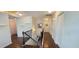 Upstairs hallway with hardwood floors, white walls, and wooden railing provides access to bedrooms at 1116 Trotter Bluffs Dr, Holly Springs, NC 27540