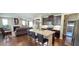 Open floor plan showcasing a spacious kitchen with dark cabinets and stainless steel appliances at 1116 Trotter Bluffs Dr, Holly Springs, NC 27540