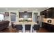 Modern kitchen featuring dark wood cabinets, a large island with granite countertops, and stainless appliances at 1116 Trotter Bluffs Dr, Holly Springs, NC 27540