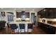 Kitchen featuring dark wood cabinets, a large island with granite countertops, and stainless appliances at 1116 Trotter Bluffs Dr, Holly Springs, NC 27540