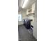 Bright laundry room featuring slate floors, white cabinets, laundry sink, and blue washer/dryer at 1116 Trotter Bluffs Dr, Holly Springs, NC 27540