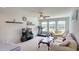 Inviting living room with three large windows, neutral walls, a fan and plush seating at 1116 Trotter Bluffs Dr, Holly Springs, NC 27540