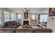 Comfortable living room with a fireplace, plush seating, and an abundance of natural light at 1116 Trotter Bluffs Dr, Holly Springs, NC 27540