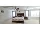 Serene main bedroom with tray ceilings, featuring a wooden bed frame and large windows for natural light at 1116 Trotter Bluffs Dr, Holly Springs, NC 27540