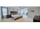 Spacious main bedroom with a tray ceiling, neutral carpet, a large bed, and ample natural light at 1116 Trotter Bluffs Dr, Holly Springs, NC 27540