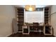 Office featuring dark wood built-ins, a large window, and a sewing machine at 1116 Trotter Bluffs Dr, Holly Springs, NC 27540