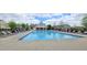 Community pool with lounge chairs for sunbathing and a cabana providing shade at 1116 Trotter Bluffs Dr, Holly Springs, NC 27540