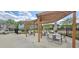 Poolside seating area with pergola providing shade for relaxing and socializing in a private setting at 1116 Trotter Bluffs Dr, Holly Springs, NC 27540