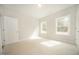 Well-lit bedroom with two windows, neutral paint, and plush carpeting at 112 Ambergate Ct, Rocky Mount, NC 27804