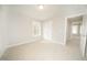 A bright bedroom with neutral colors and carpet features a window and closet at 112 Ambergate Ct, Rocky Mount, NC 27804