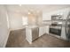 Open kitchen features granite countertops, stainless steel appliances, and an island at 112 Ambergate Ct, Rocky Mount, NC 27804