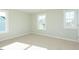 Bright bedroom features neutral walls, carpet flooring, and multiple windows offering natural light at 117 Ambergate Ct, Rocky Mount, NC 27804