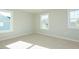 Bright bedroom features neutral walls, carpet flooring, and multiple windows offering natural light at 117 Ambergate Ct, Rocky Mount, NC 27804