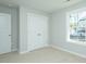 Carpeted bedroom with light walls, closet, window, and white trim creating a serene space at 117 Ambergate Ct, Rocky Mount, NC 27804