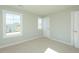 Bedroom with beige carpet, light walls, a window, and a closet with white paneled doors at 117 Ambergate Ct, Rocky Mount, NC 27804