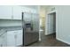 Bright kitchen with stainless steel refrigerator, granite counters, and white cabinetry at 117 Ambergate Ct, Rocky Mount, NC 27804