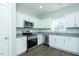 Bright kitchen with white cabinetry, stainless appliances, and granite countertops offer a modern look at 117 Ambergate Ct, Rocky Mount, NC 27804
