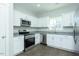 Bright kitchen with white cabinetry, stainless appliances, and granite countertops offer a modern look at 117 Ambergate Ct, Rocky Mount, NC 27804