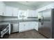 Well-lit kitchen features stainless steel appliances, granite countertops, and white cabinets at 117 Ambergate Ct, Rocky Mount, NC 27804