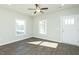 The large living room boasts hardwood flooring, natural light, and a ceiling fan at 117 Ambergate Ct, Rocky Mount, NC 27804