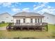 Expansive backyard featuring a deck with awning, lush greenery, and mature trees creating a private oasis at 1201 Pleasant Falls Ct, Wake Forest, NC 27587