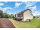 Beautifully landscaped backyard featuring a deck, patio and green lawn at 1201 Pleasant Falls Ct, Wake Forest, NC 27587