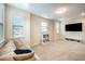 Spacious bonus room with plenty of natural light, plush carpeting and large TV for versatile use at 1201 Pleasant Falls Ct, Wake Forest, NC 27587