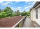 Spacious deck with wood flooring and black railing offering a serene outdoor living space with lush green views at 1201 Pleasant Falls Ct, Wake Forest, NC 27587
