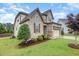 Well-maintained two-story home with stone and siding, complemented by professional landscaping at 1201 Pleasant Falls Ct, Wake Forest, NC 27587