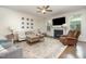 Cozy living room featuring hardwood floors, a fireplace, and comfortable seating arrangements at 1201 Pleasant Falls Ct, Wake Forest, NC 27587