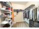Spacious walk-in closet with shelving and hanging racks for efficient storage at 1201 Pleasant Falls Ct, Wake Forest, NC 27587