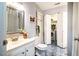 Clean bathroom featuring a vanity, toilet, and closet leading to the laundry room at 121 Westview Dr # 22, Carrboro, NC 27510
