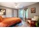 Cozy bedroom featuring a ceiling fan, access to a screened porch, and neutral colors, providing a relaxing atmosphere at 121 Westview Dr # 22, Carrboro, NC 27510